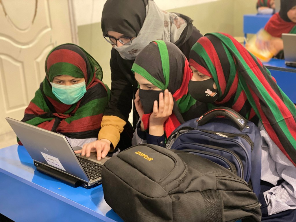Afghan girls studying together.